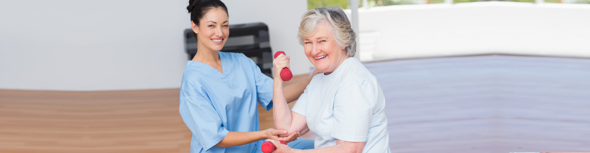 caregiver with elder woman exercising